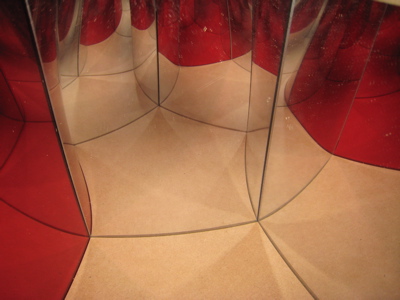 Using one red mirror shows how the extra hyperbolic space is folded away to fit in Euclidean space.